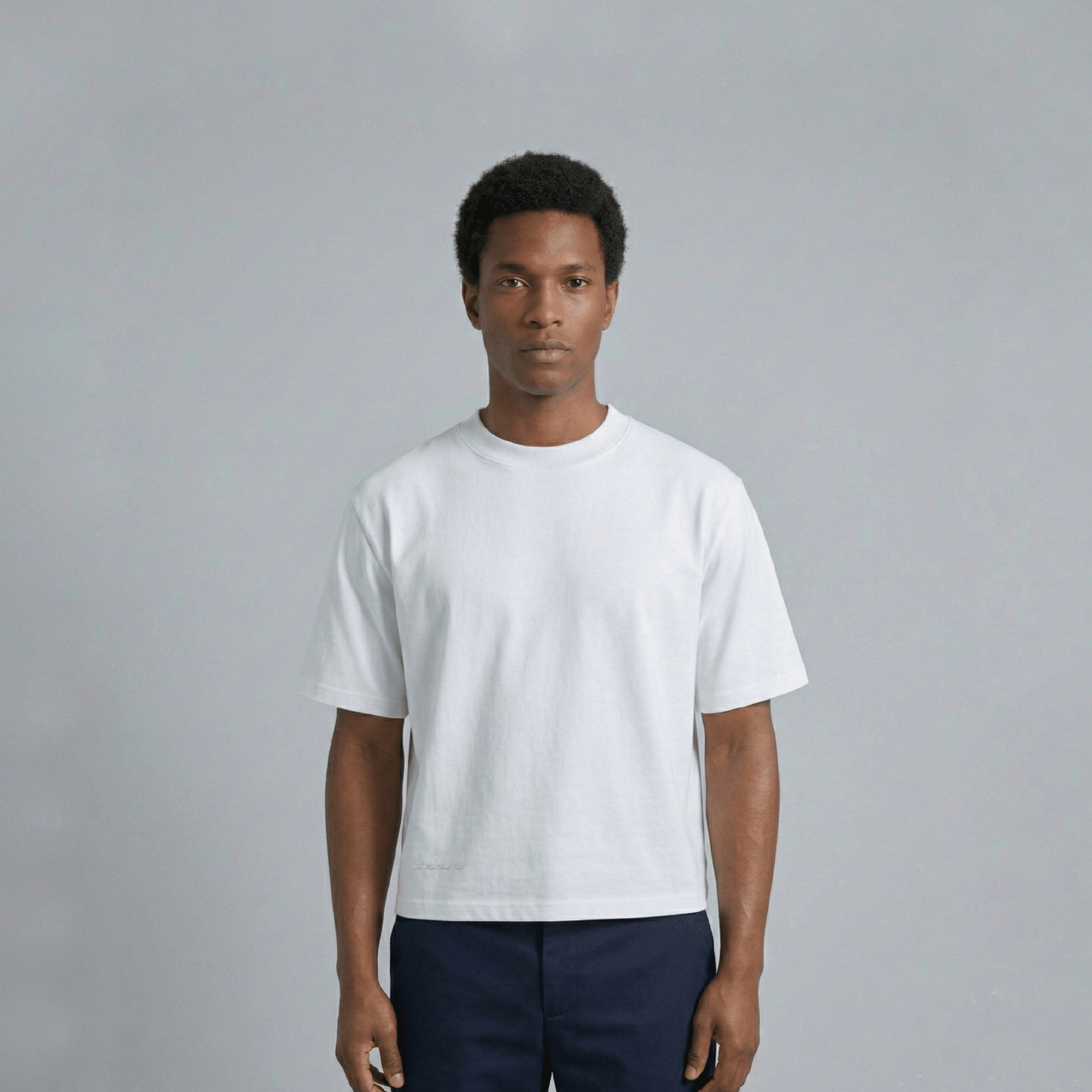 THBC Basic Tee in white, model wearing size M, front view