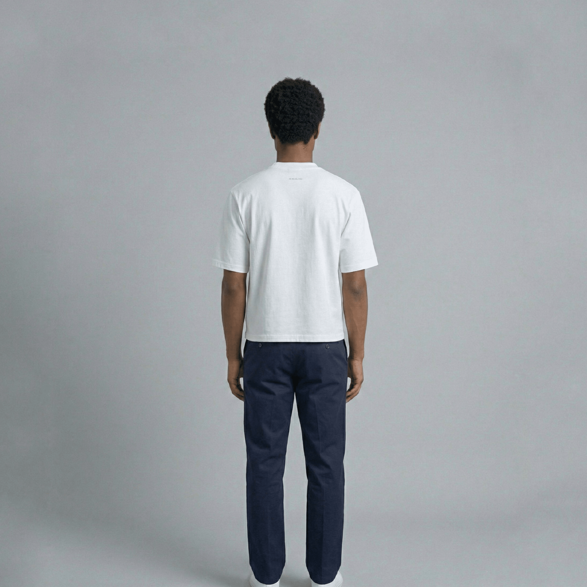 THBC Basic Tee in white, model wearing size M, rear view